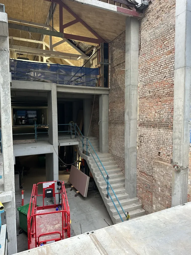 Building construction site with scaffolding and equipment.