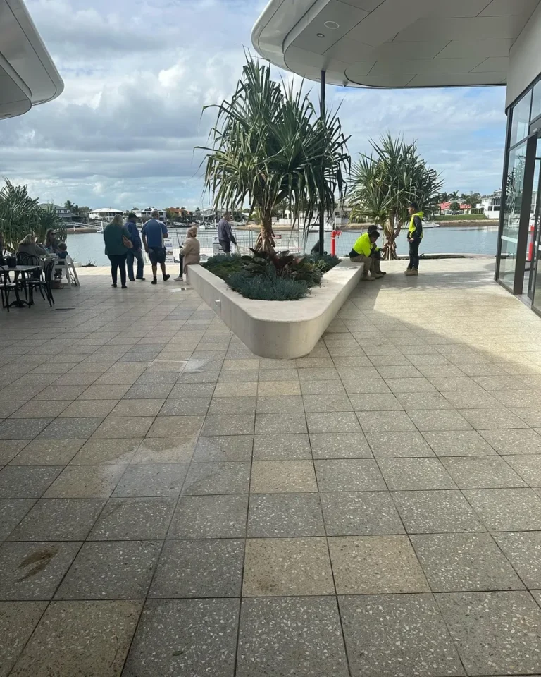 People standing near waterfront, modern open space.