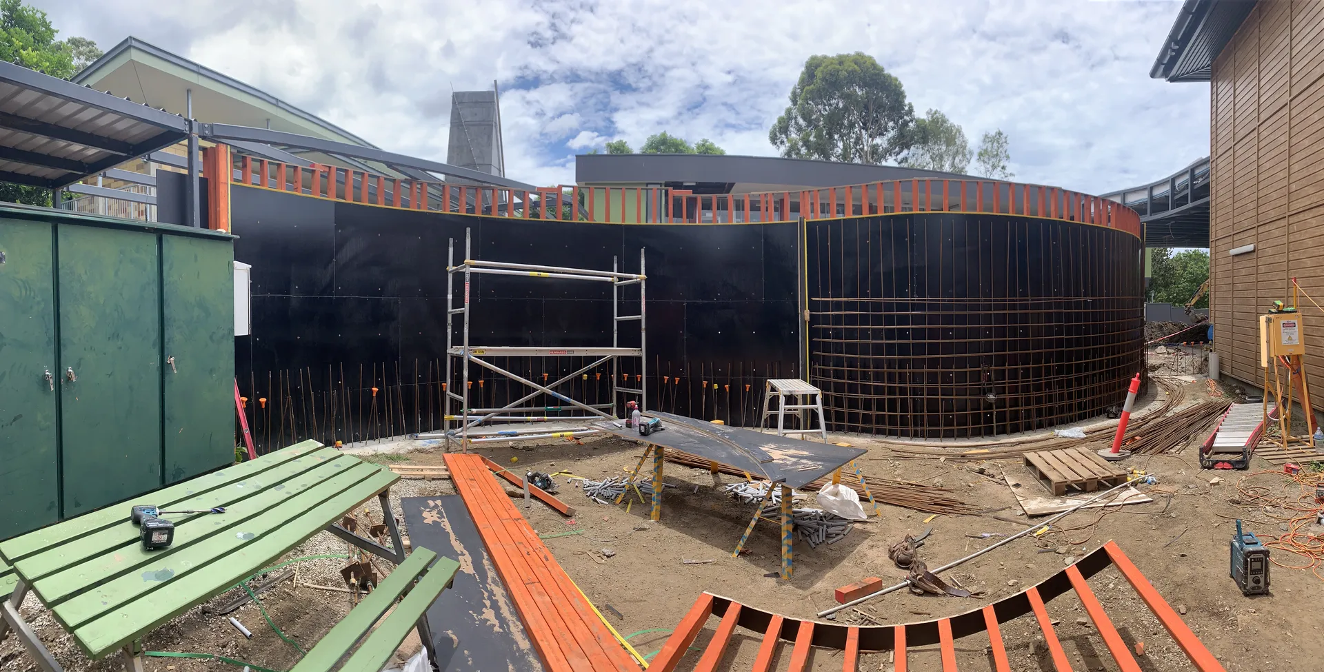 Construction site with scaffolding and building materials.