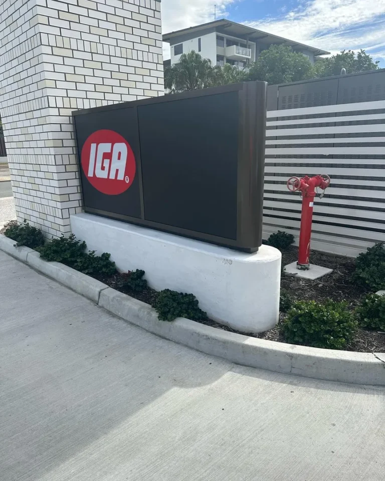 IGA store sign near hydrant and building.