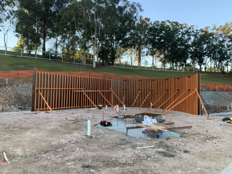 Construction site with wooden framework and trees background
