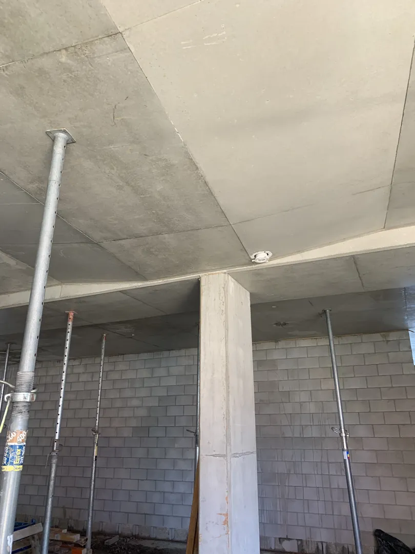 Concrete slab ceiling with support columns and walls.