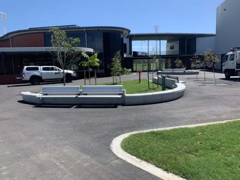 Modern building with vehicles parked outside