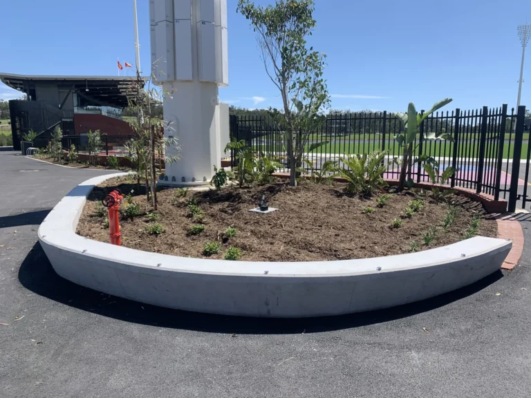 Garden near pedestrian path and sports facility.