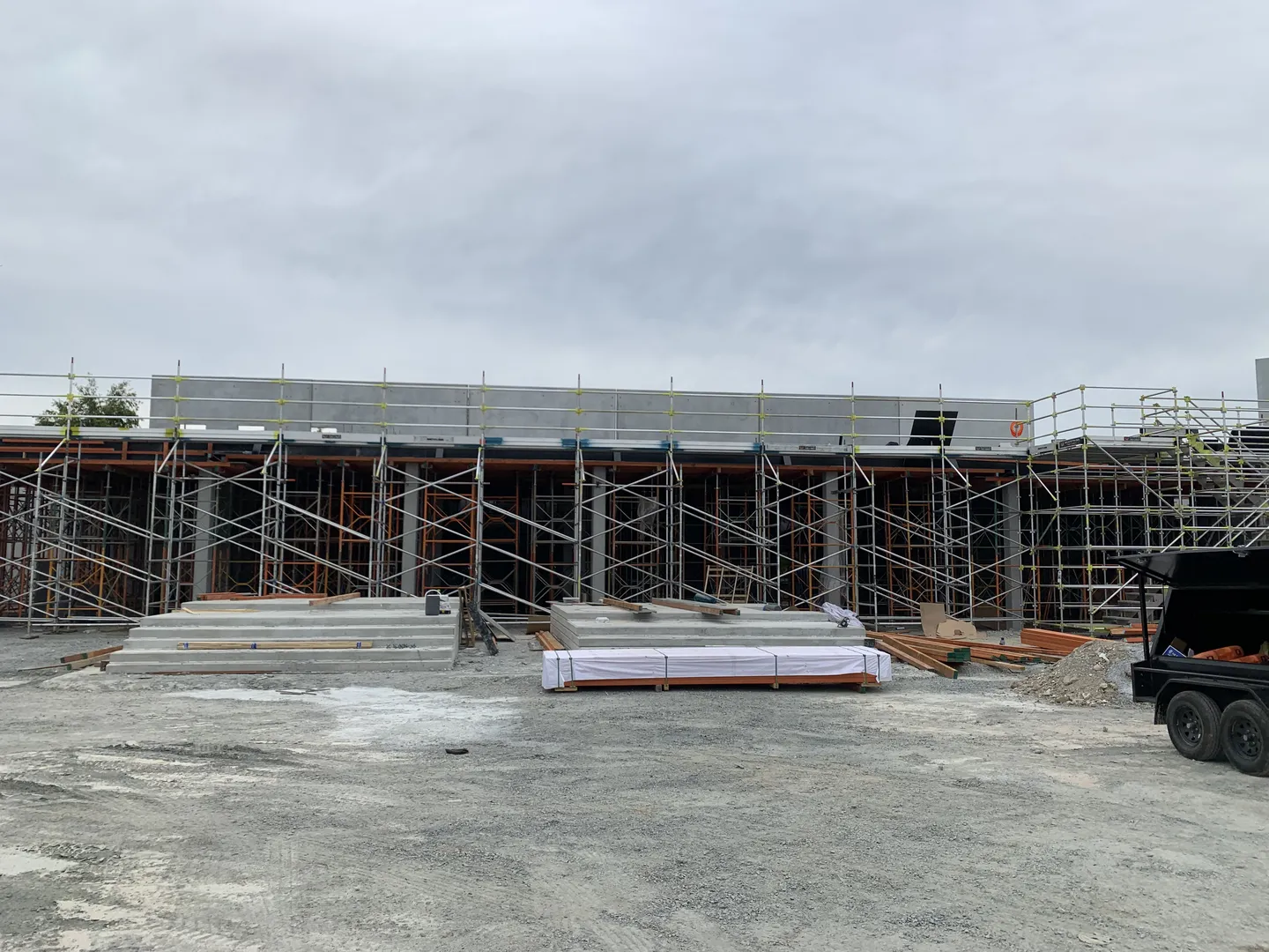 Construction site with scaffolding and building materials.