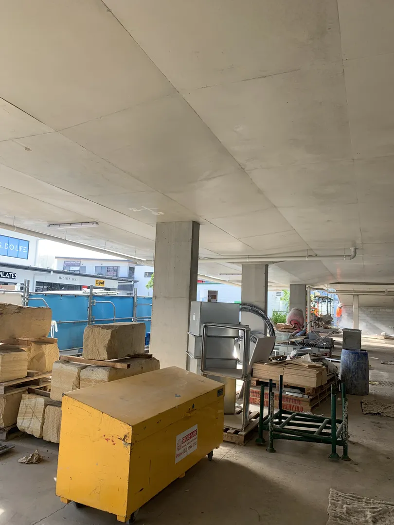 Construction equipment and materials under a building.