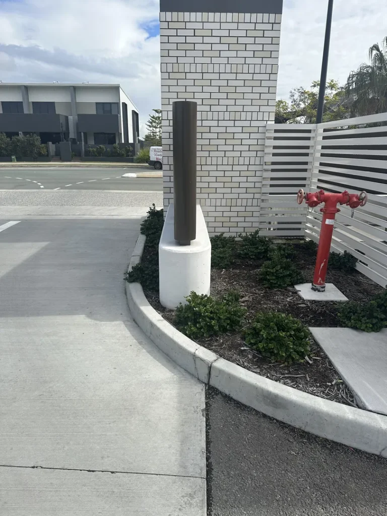 Concrete slab with bollard by building entrance