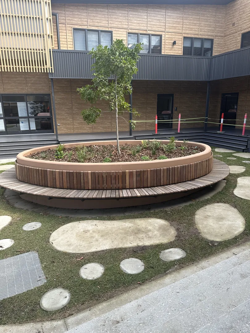 Circular planter with tree in courtyard