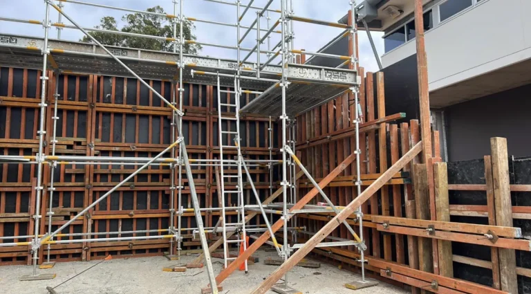 Construction site with scaffolding and wooden framework.
