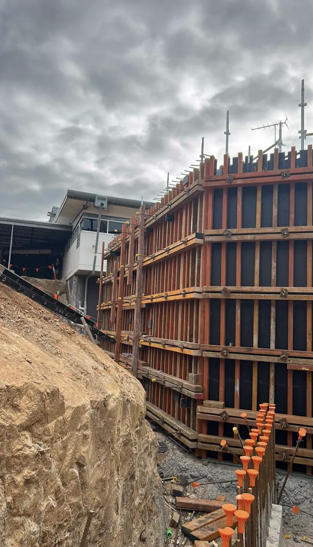 Construction site with wooden structures and building