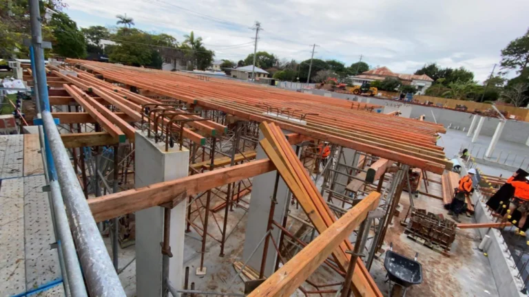 Construction workers building a wooden framework.