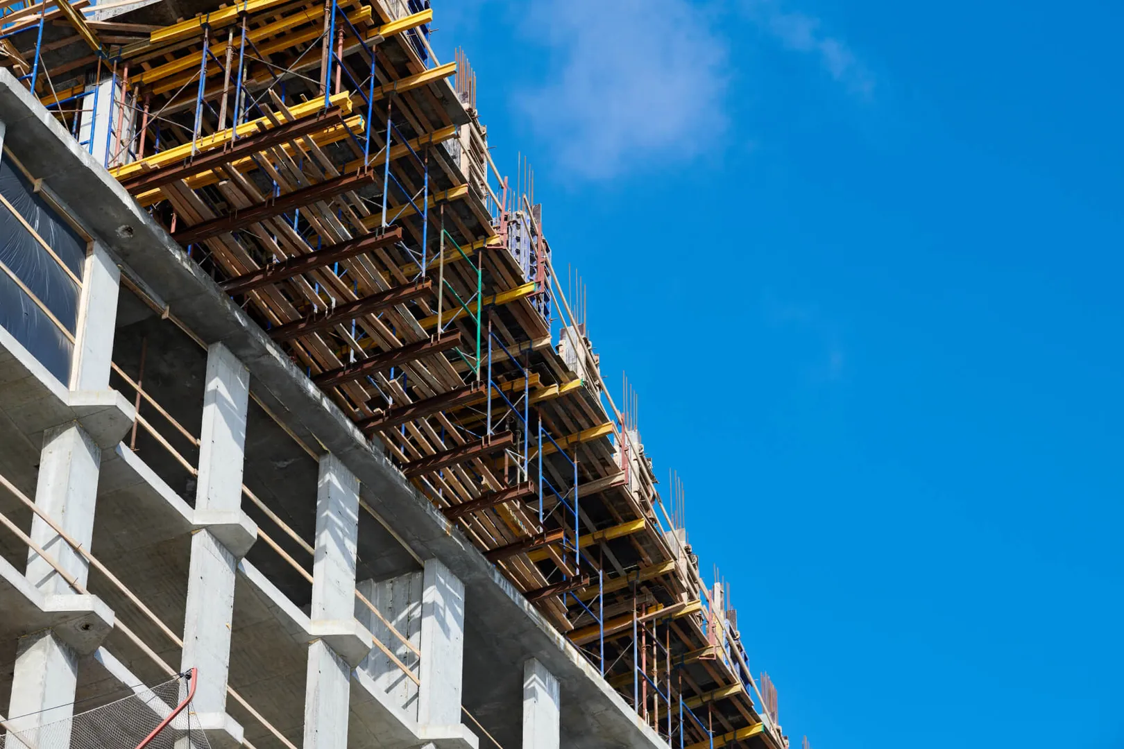 Construction site with scaffolding and clear blue sky