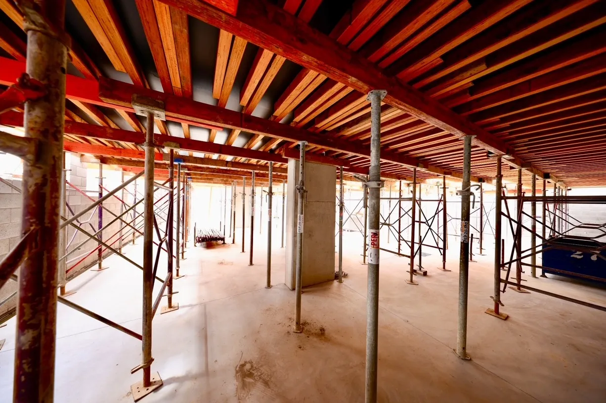 Construction site with scaffolding and wooden beams.